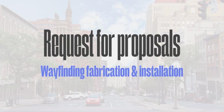 Streetscape of Downtown Albany NY with text "Request for proposals Wayfinding fabrication and installation" centered over image