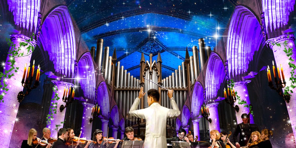 Orchestra conductor shown at center with orchestra to left and right with organ pipes in background