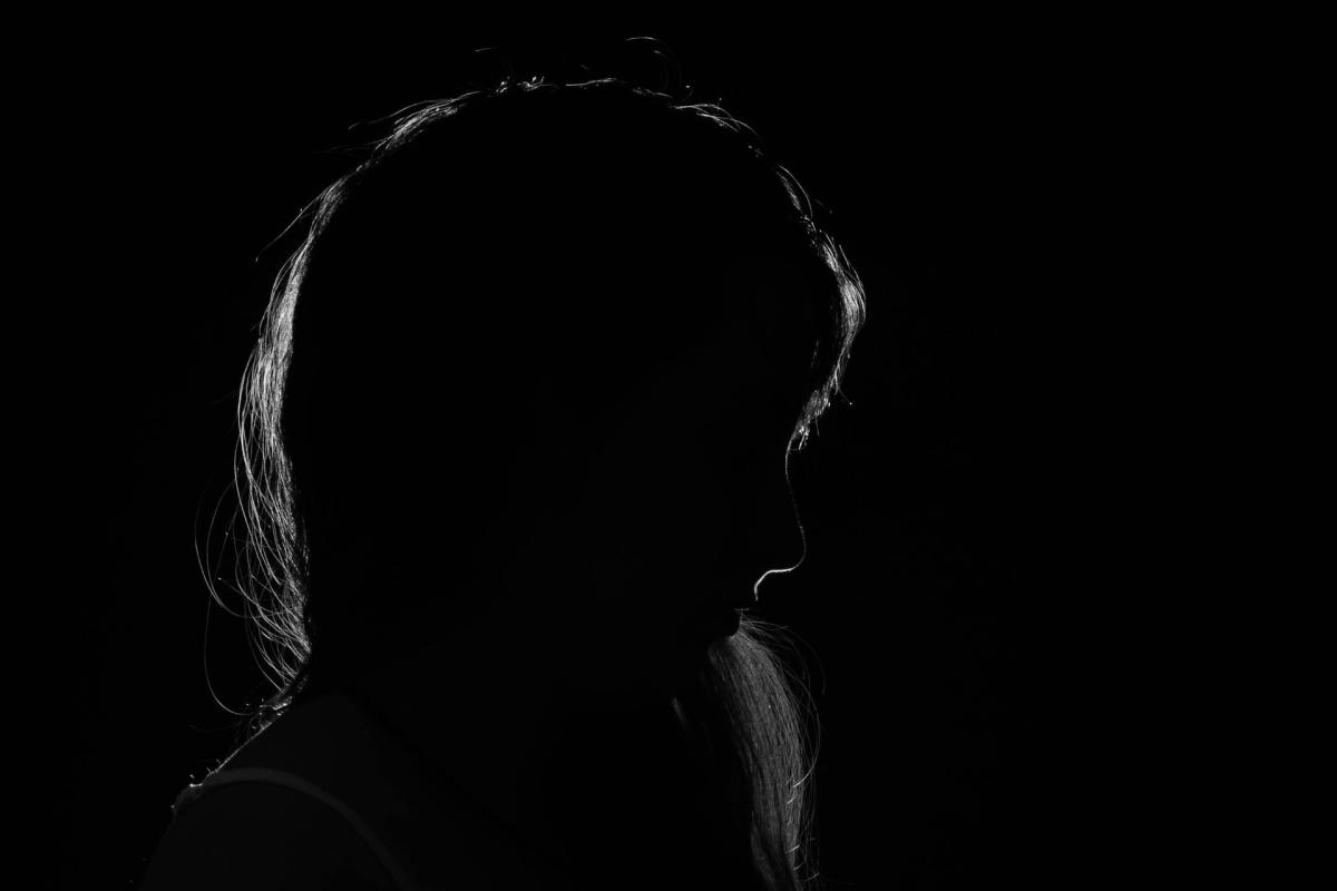Woman in silhouette on dark background