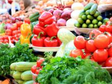 Photograph of a variety of fresh produce items at a farm stand.