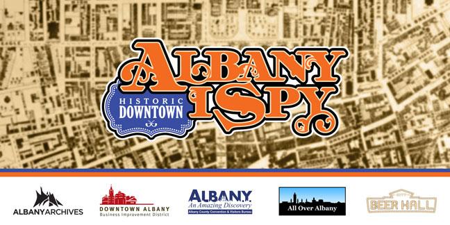 Albany I Spy logo over a sepia toned image of a map