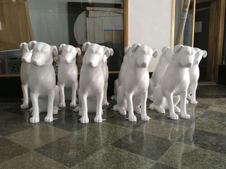 10 blank nipper dog statues sit in a row