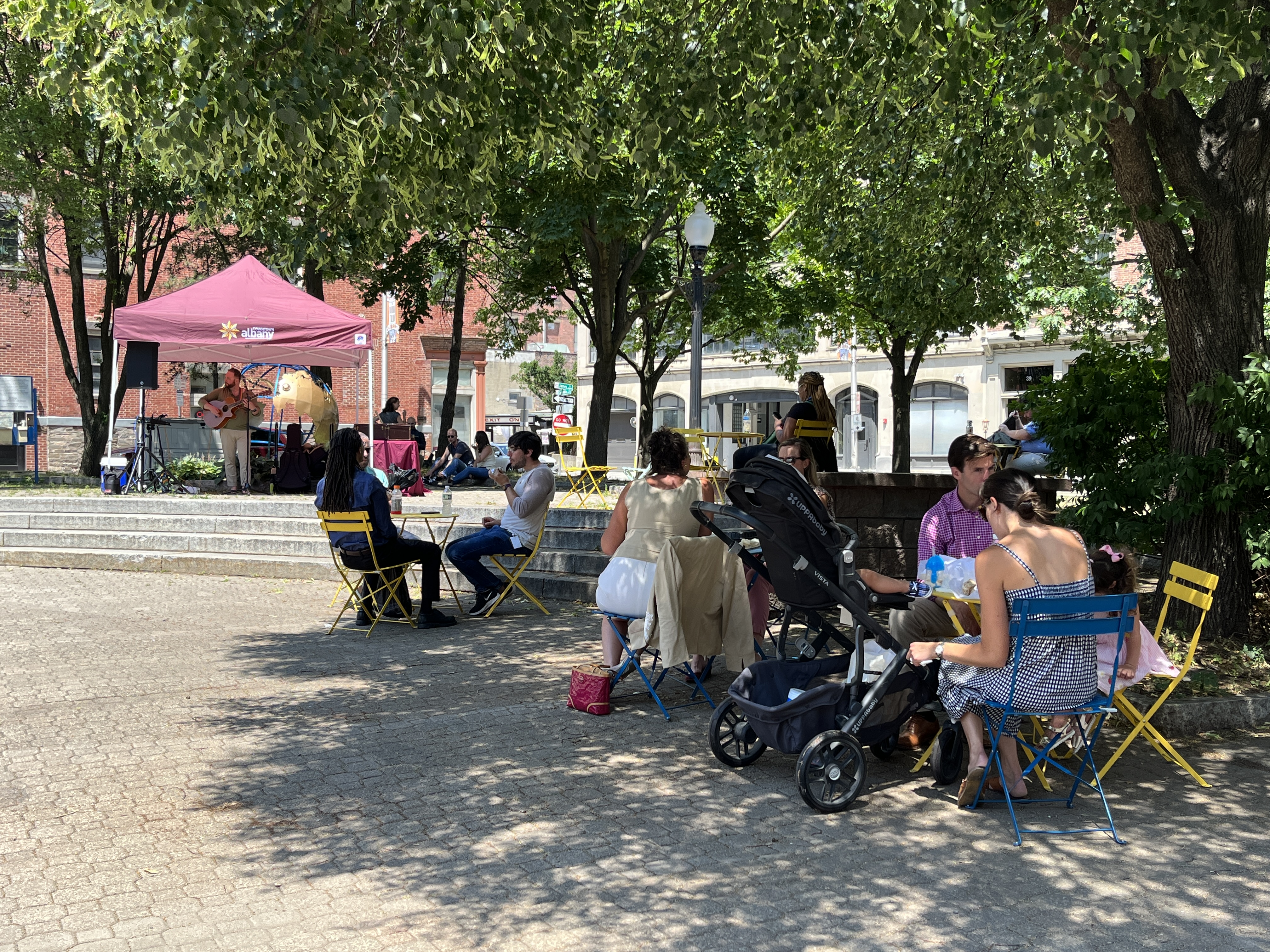 People sitting in a park in downtown Albany