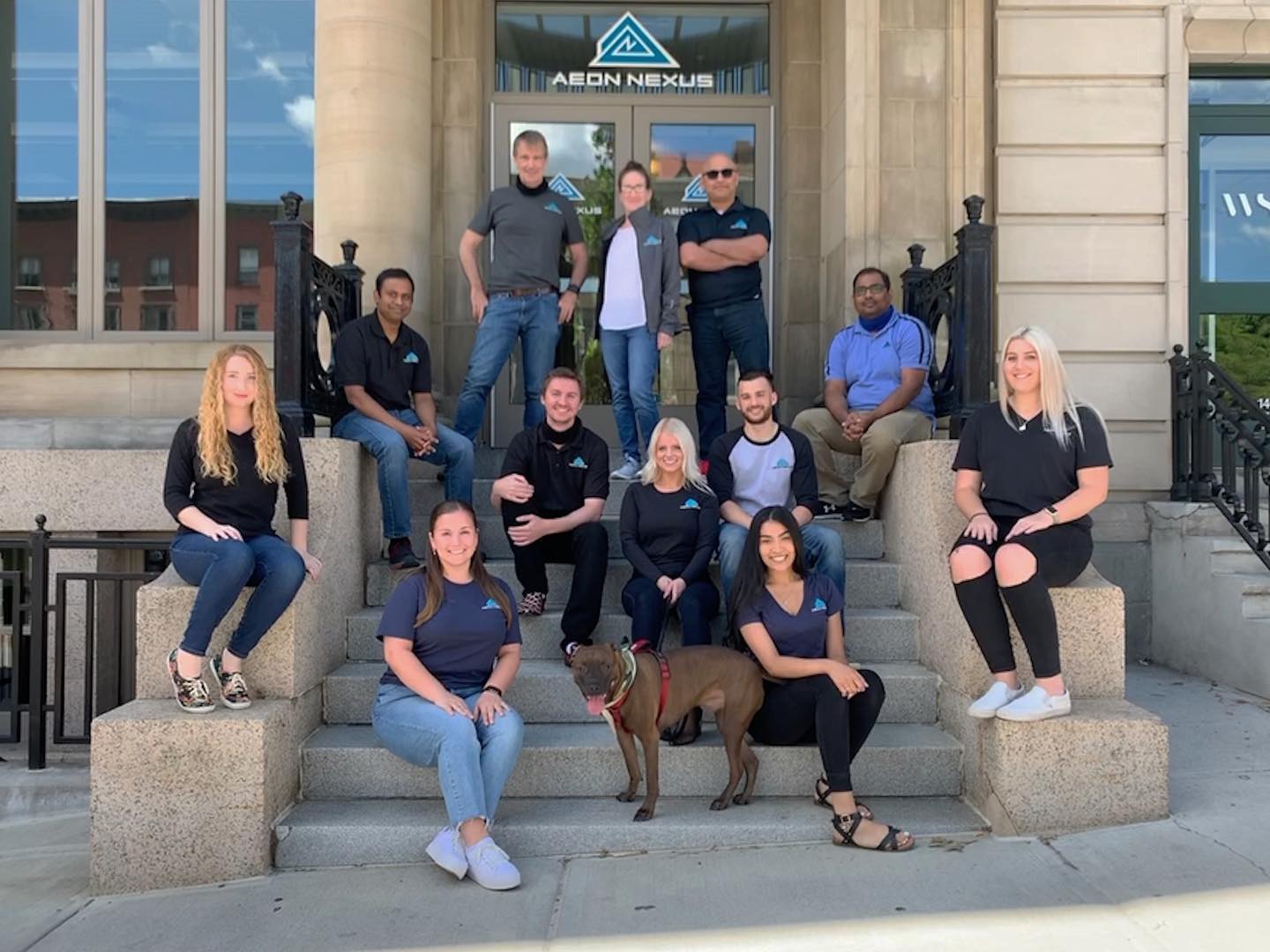 Group of employees sit on stairs