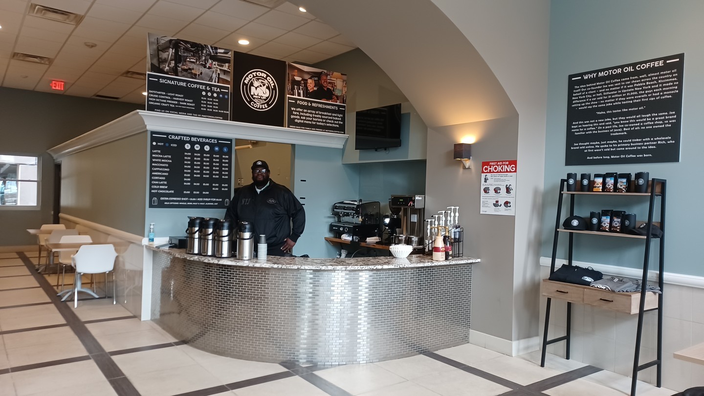 Employee stands behind counter at Motor Oil Coffee