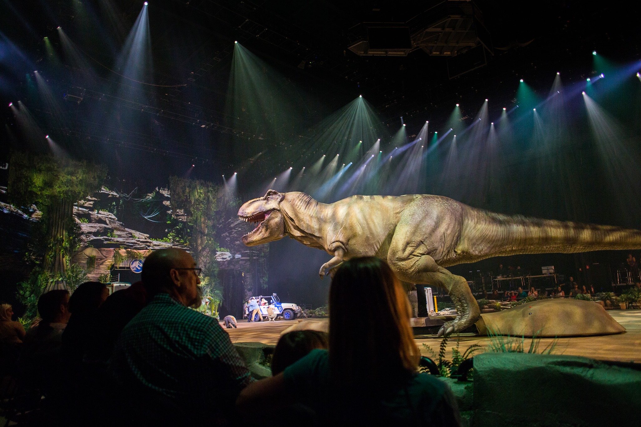Audience watches show with t-rex and jeep in background