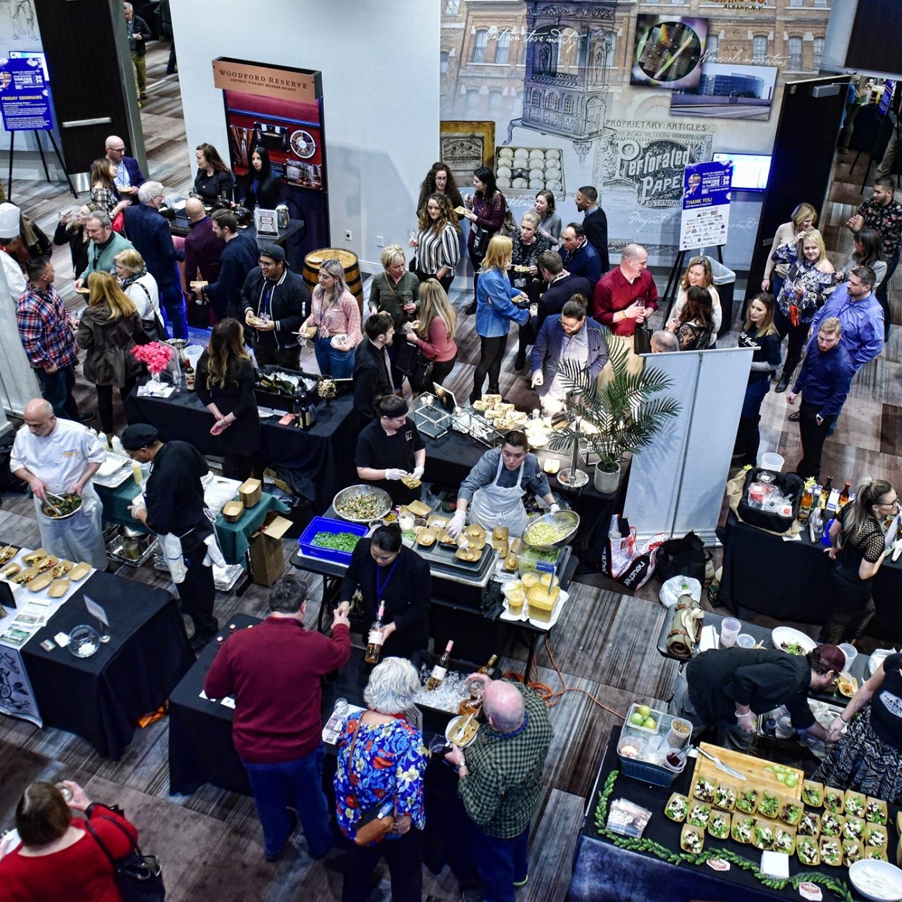 High view of people exploring tables featuring restaurants serving food