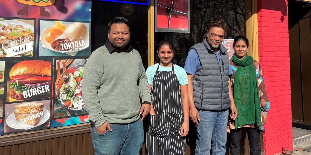 The four owners of Hungry Bites, a Downtown Albany NY eatery, stand in front of their business