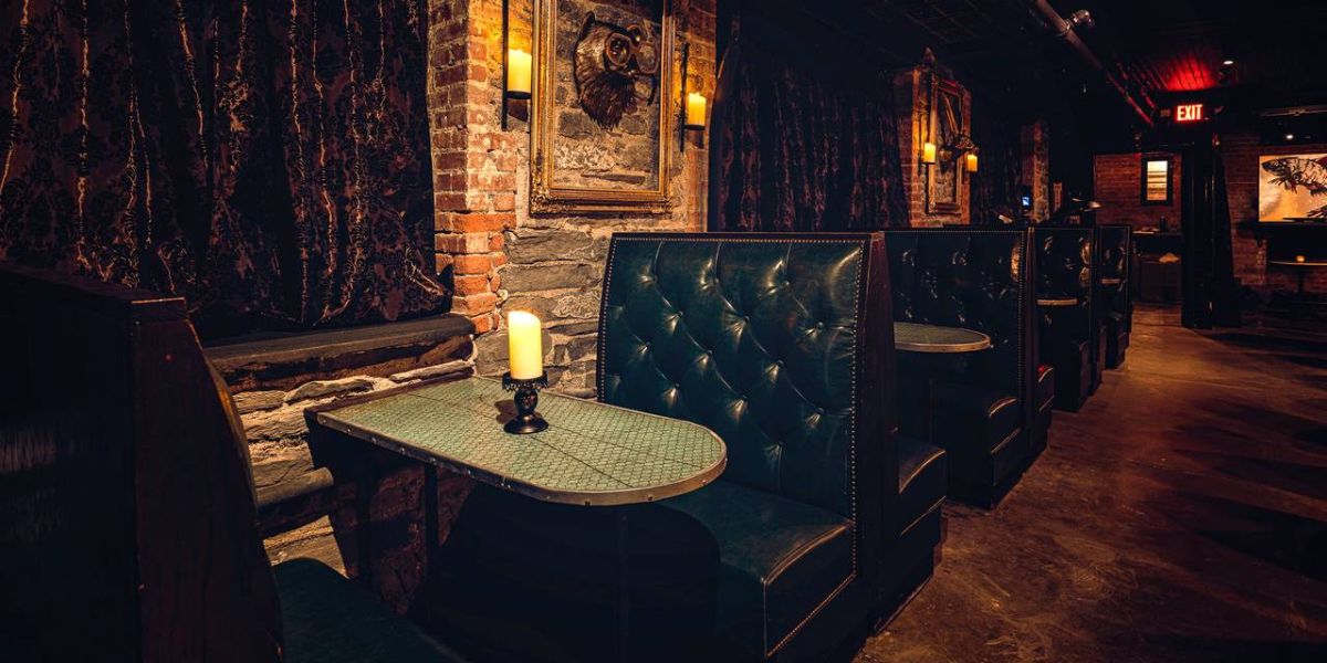 Lounge area seen with booth seats and candle sitting on top of table