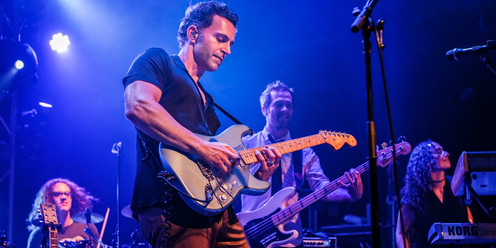 man playing guitar on stage