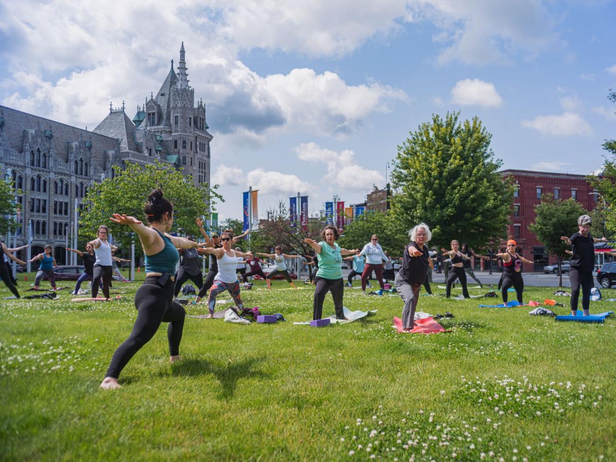 People doing yoga at SUNY Plaza
