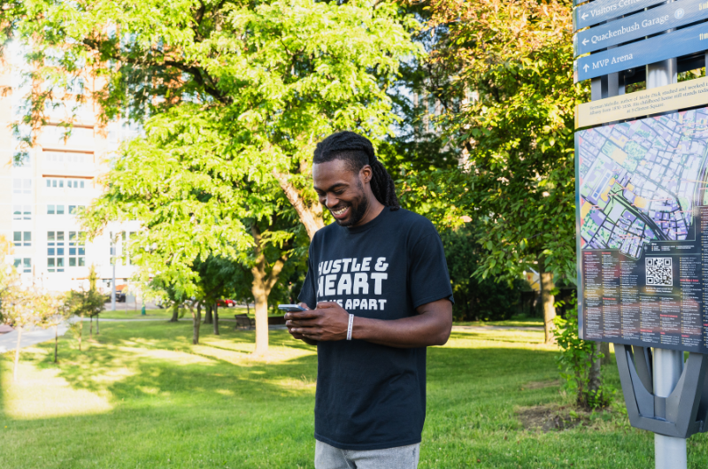 guy on phone in downtown albany