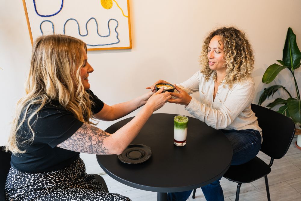 two women enjoying coffee at Alias