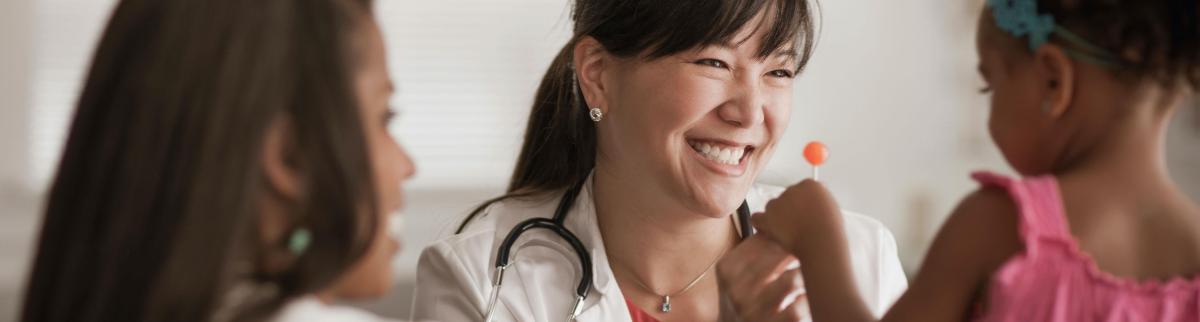 Doctor giving child lollipop