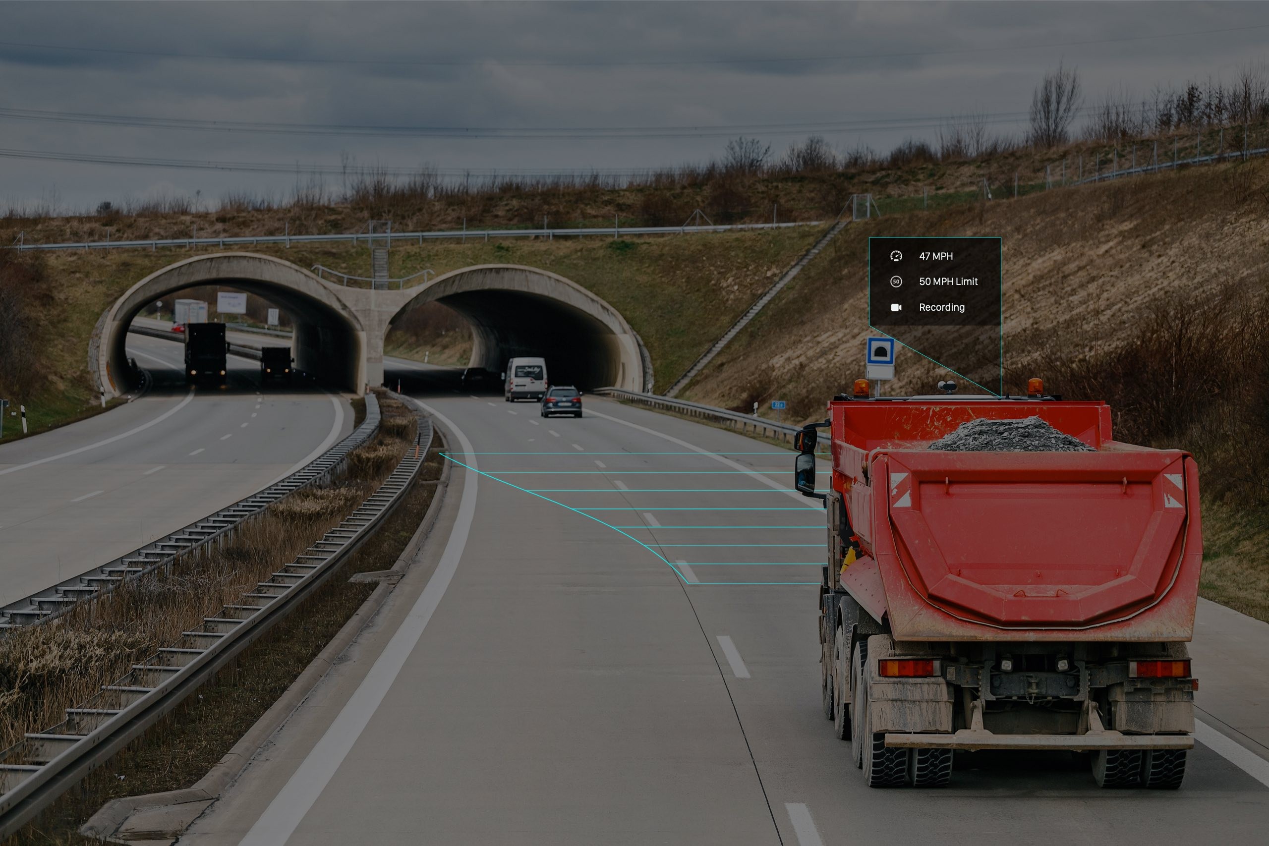 Dump truck with load traveling along highway