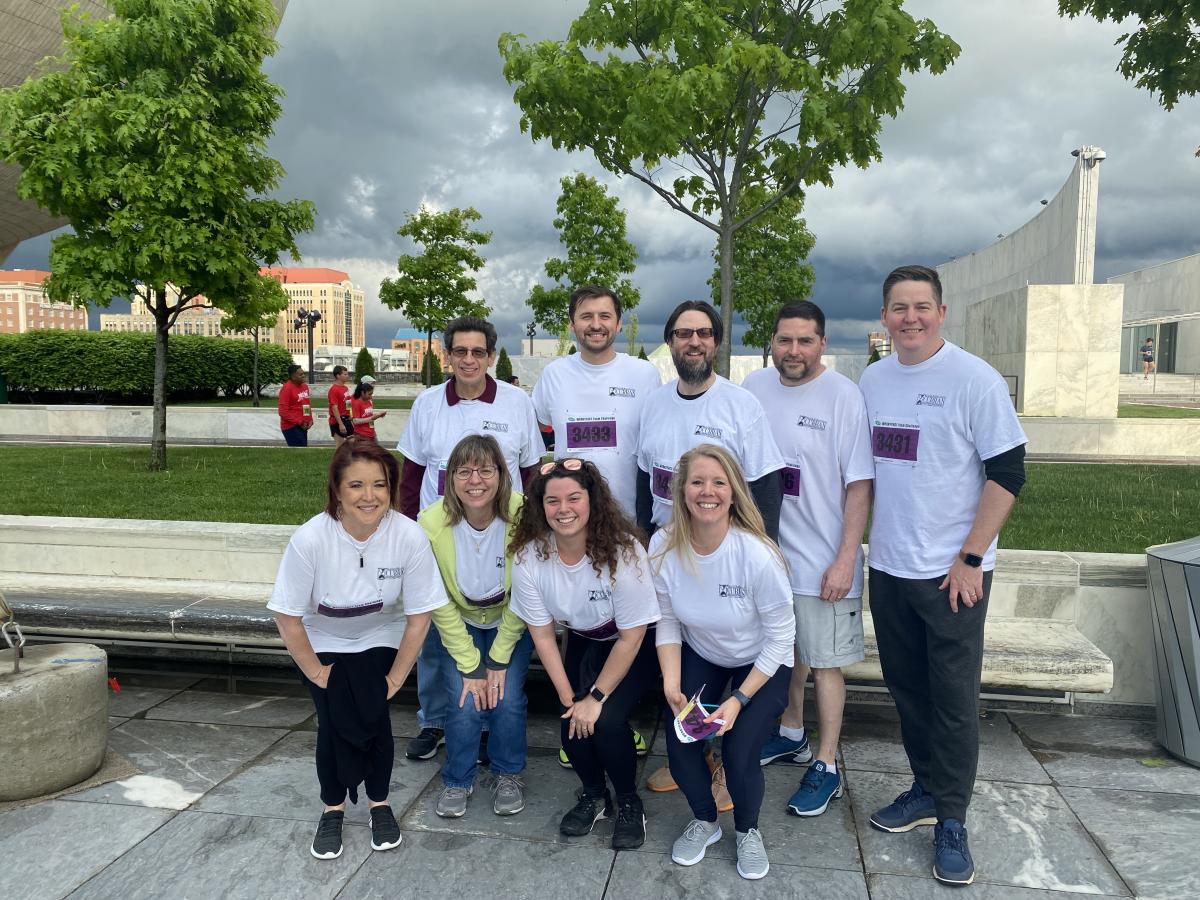 Curran Investment staff in matching shirts outside in tight grouping