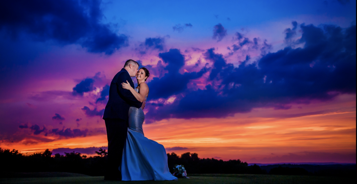 Bride and groom wedding photograph with sunset in background