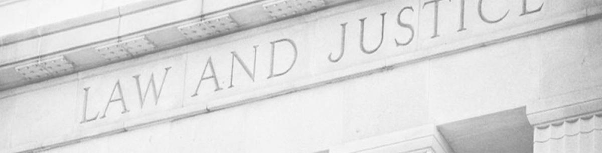 Close up of court building with words Law and Justice on it