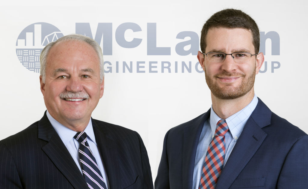 McLaren leaders in front of McLaren logo on wall