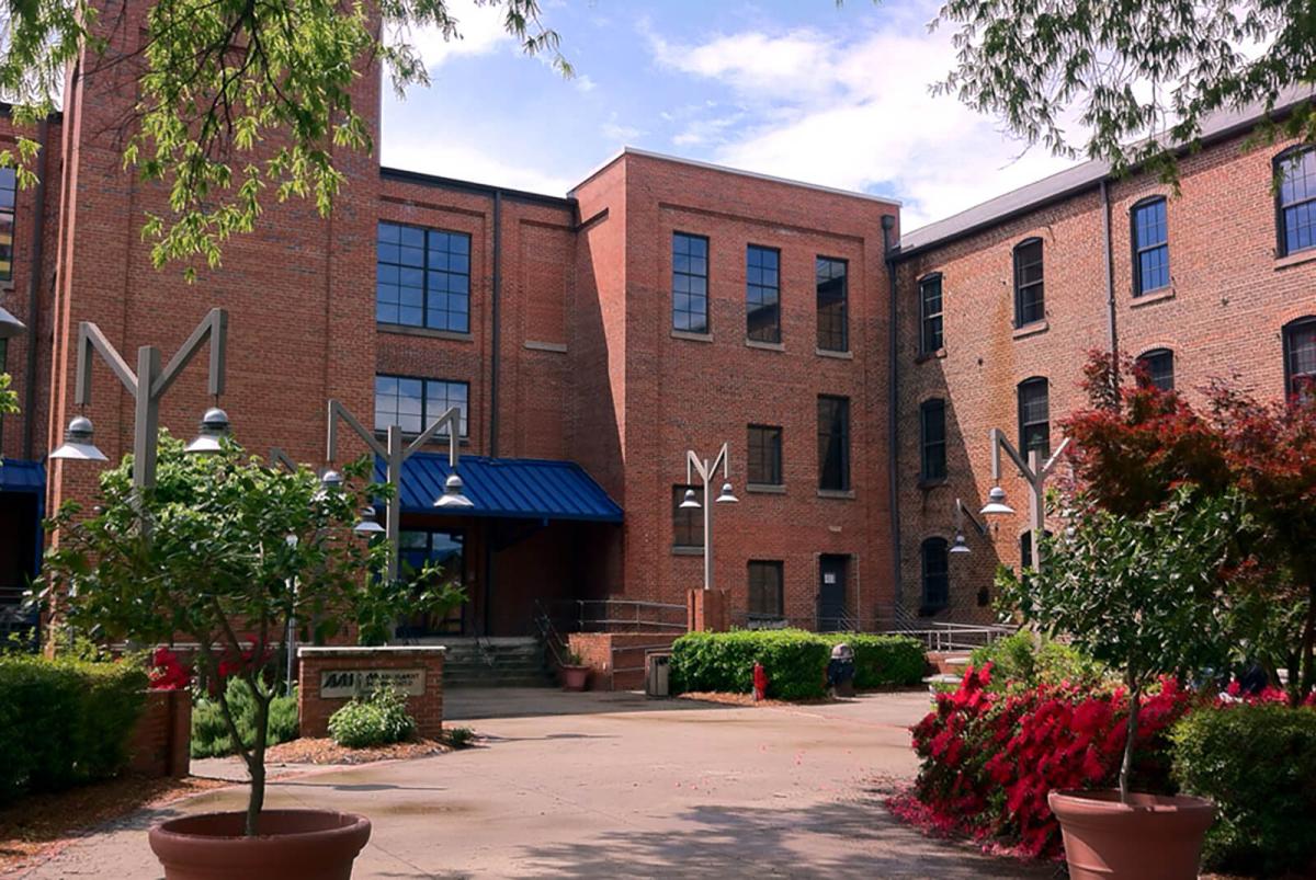 Courtyard with L-shaped brick building