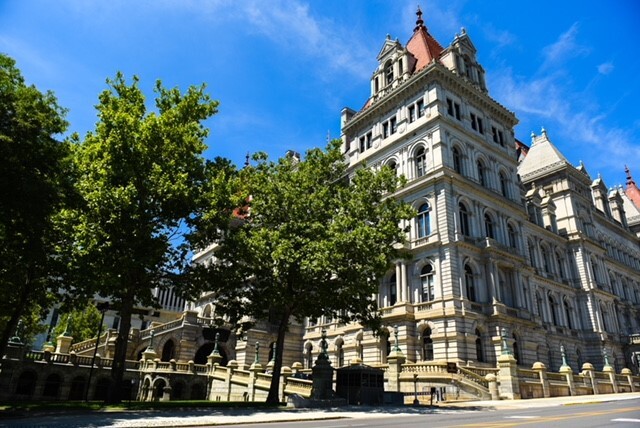 Corner of the New York State Capitol building with blue sky
