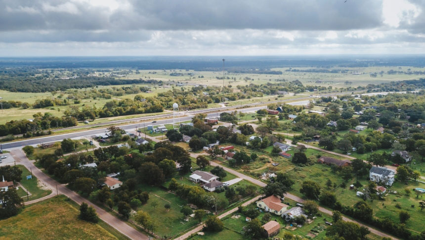 Aerial view of houses and farms and fields