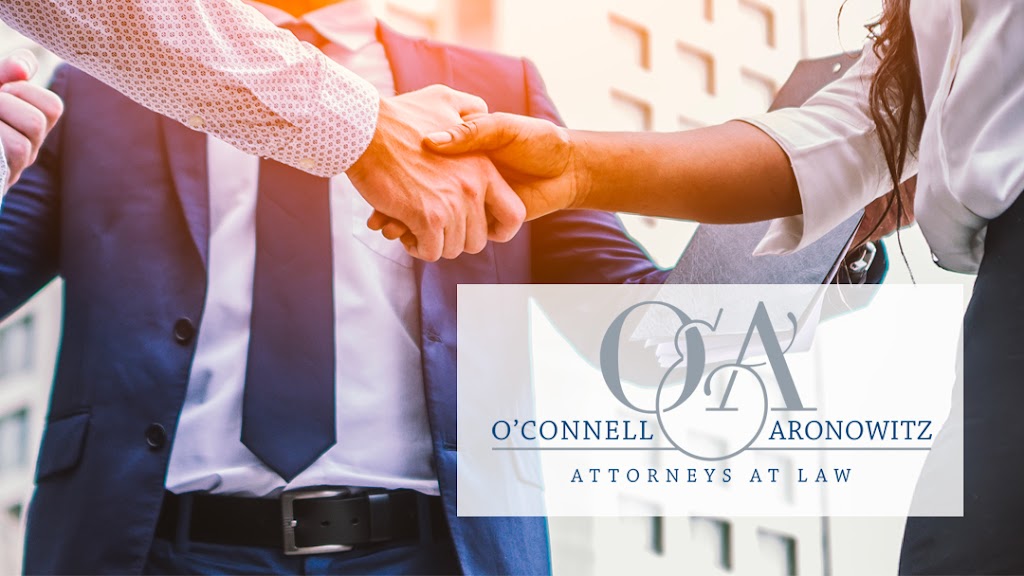 Photo of a business handshake with O'Connell & Aronowitz logo overlaid on it