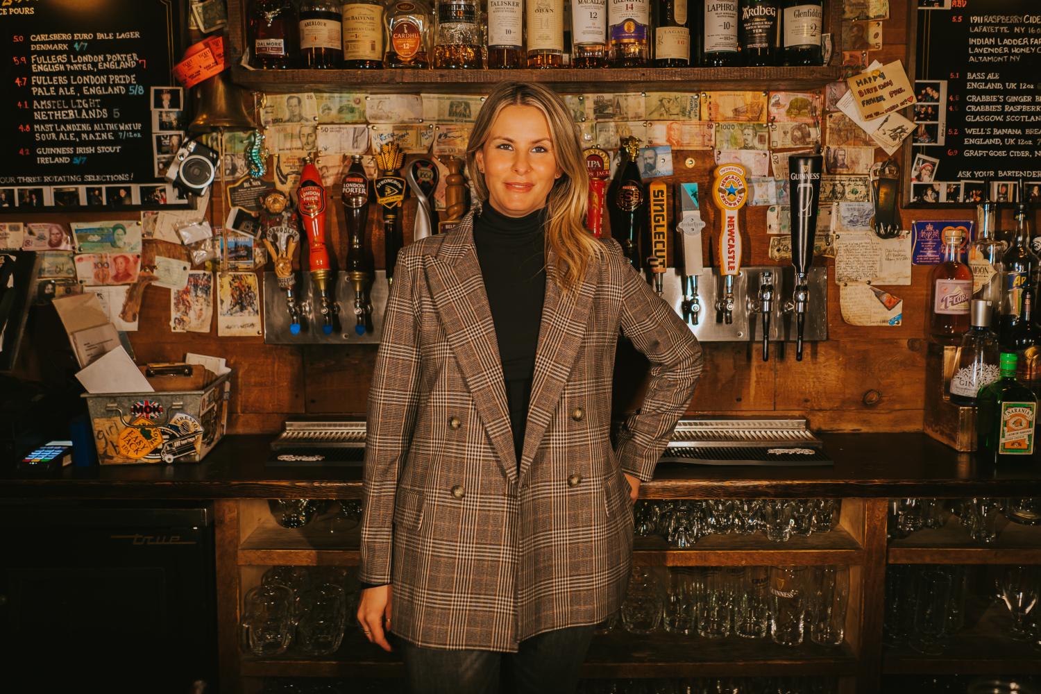 interior view of Olde English Pub with a woman in front of the beer selection