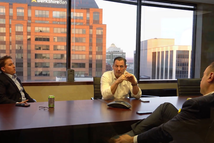 Men in conference room with view of Albany out windows