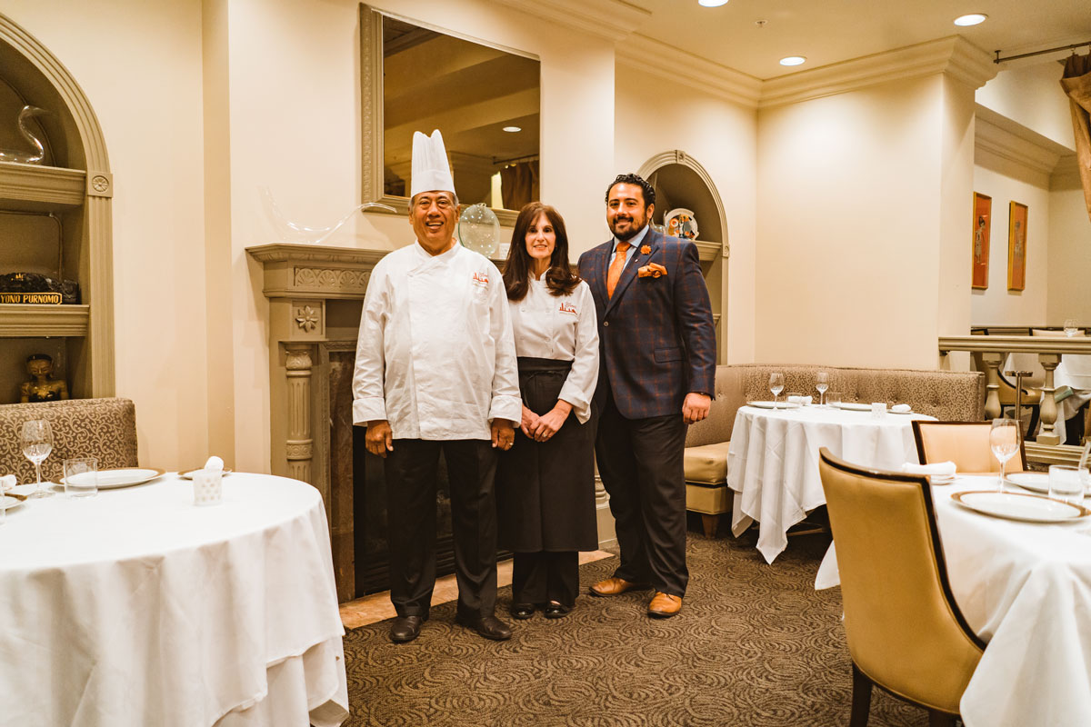 Owners of Yono's Restaurant and Head Chef stand in the dining area