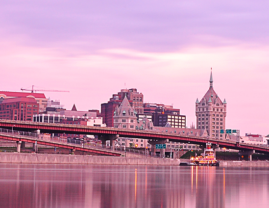 Purple and pink toned photo of the skyline of Albany