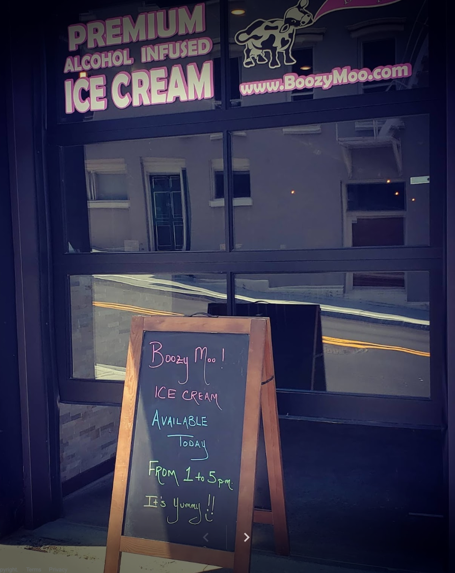 Exterior of Boozy Moo with sandwich board