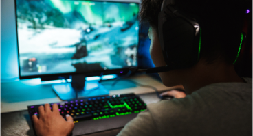 Boy playing video game on computer