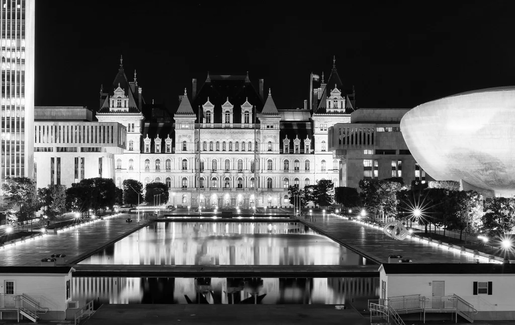 Black and white photo of Empire State Plaza with reflecting pool, The Egg and New York State Capitol building