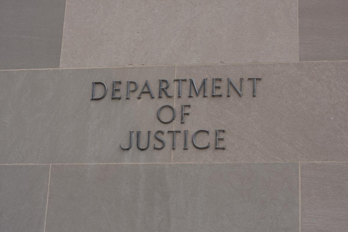 Department of Justice sign on marble wall