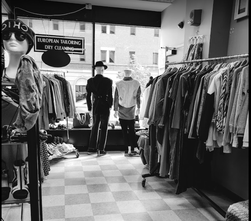 Black & white interior of European Tailoring & Alteration with garment racks and mannekins