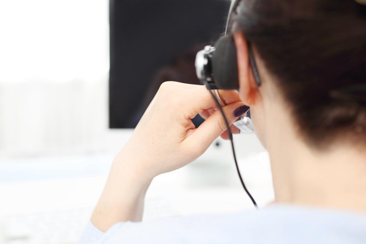 Back of woman with headset talking on phone