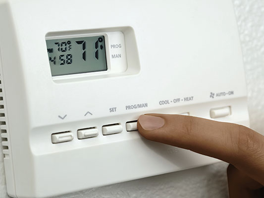 Finger adjusting home thermostat