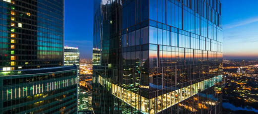 Blue highrise glass buildings reflecting the sky