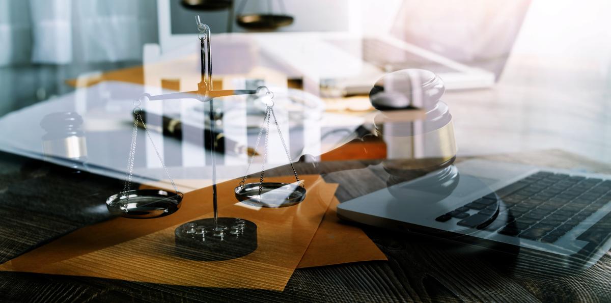 Collage of legal symbols on desk with computer