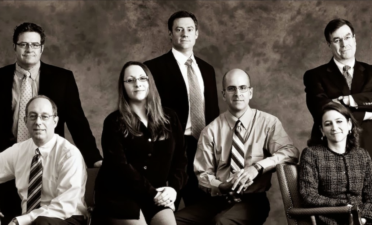 Sepia toned portrait of law firm employees