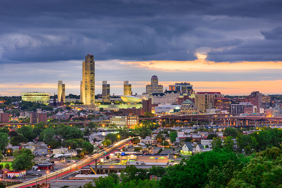 Dramatically colored and lit skyline of Albany at twilight