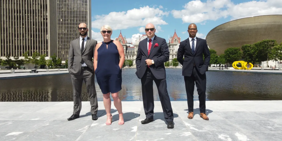 Real estate agents standing at Empire State Plaza in Albany, NY