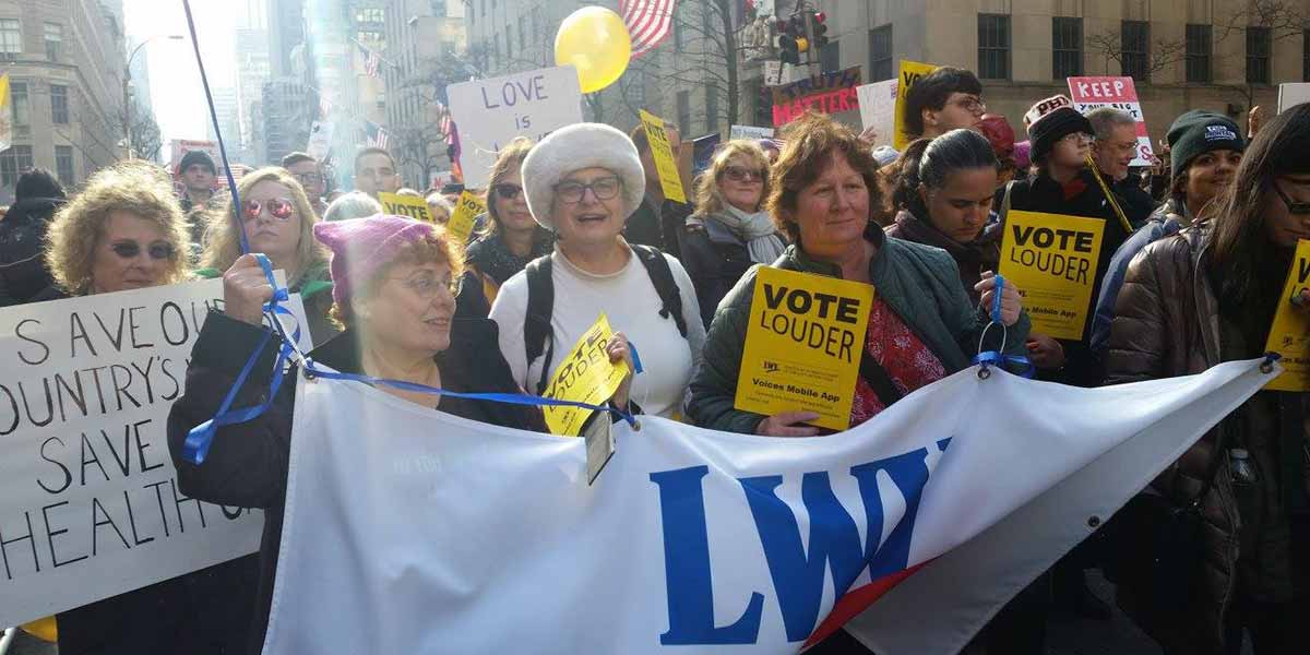 Women's march with signs and banners