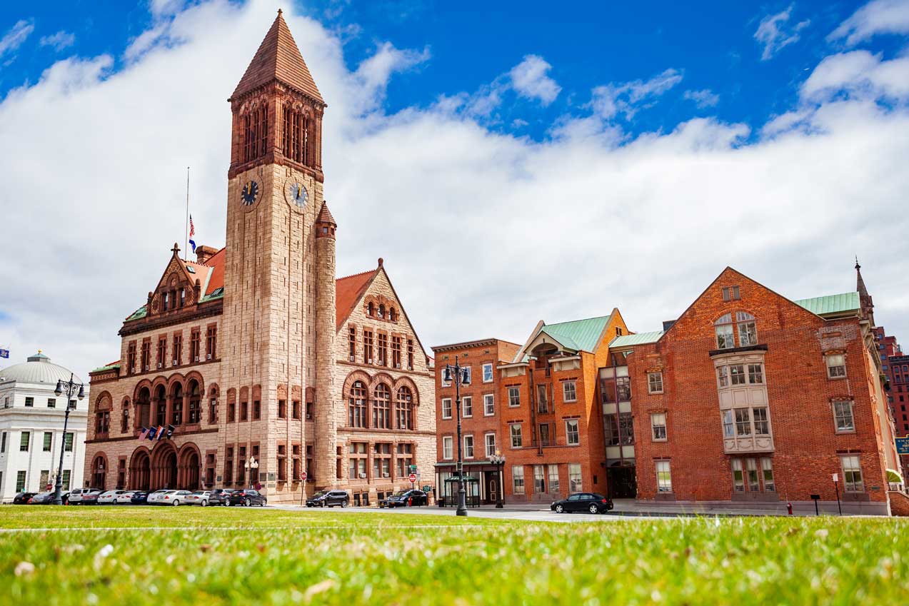 Albany City Hall building against a cloudy blue sky 