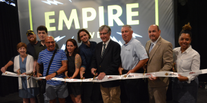 Group stands in line at ribbon cutting for Empire Live