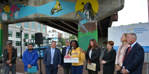 Artist D. Colin speaks at a press event celebrating Capital Walls mural