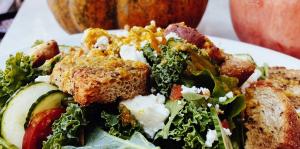 Salad seen in foreground with pumpkin in background