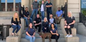 Group of employees sit on stairs