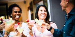 Three people hold margaritas